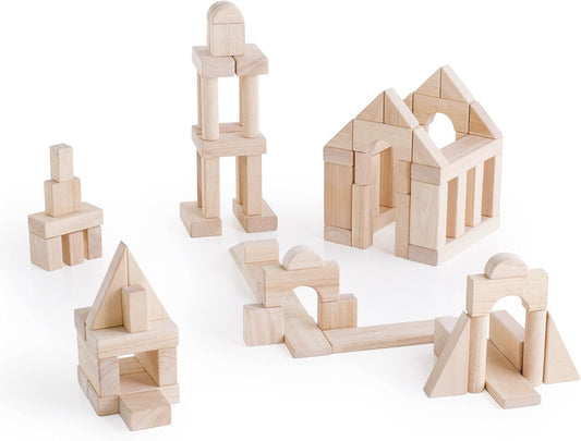 Natural wooden unit blocks, arches and cylinders stacked into a small building