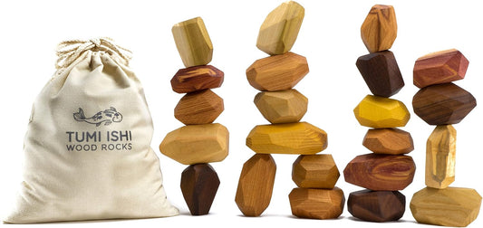 Stack of smooth wooden rock-shaped blocks in light and dark wood tones balanced on a table