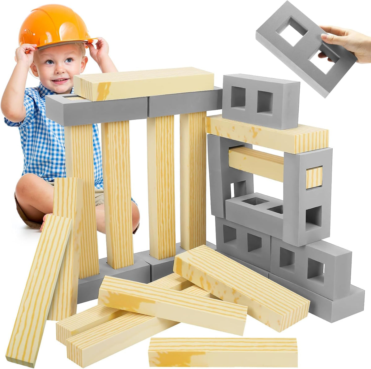 Gray foam building bricks of assorted sizes stacked into a small wall