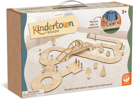 Wooden toddler road pieces laid out as a small town