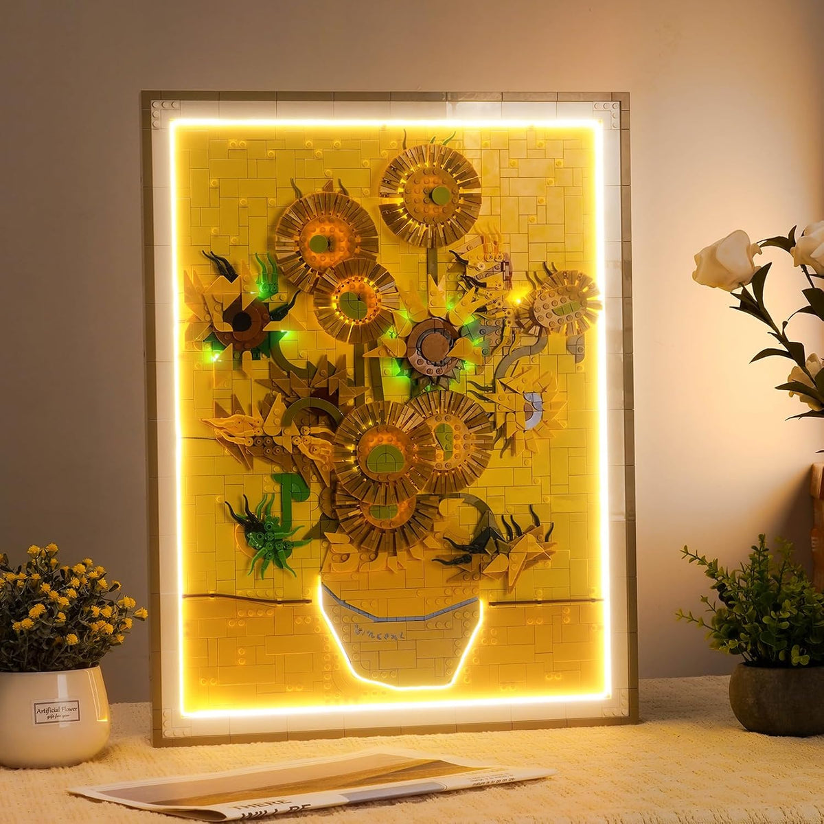Brick-built sunflowers in a vase painting lit by soft LED lights on a wall