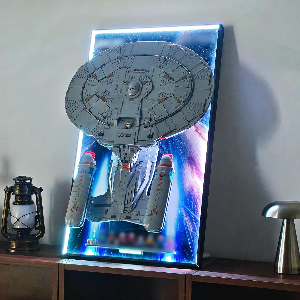 Wall-mounted display board with color LED backlight holding a starfighter model – view 2