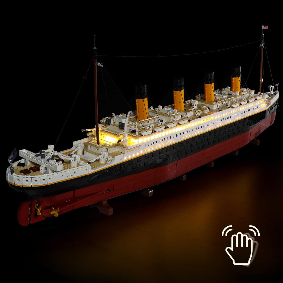 Brick-built ocean liner model with portholes and decks lit by LED lights