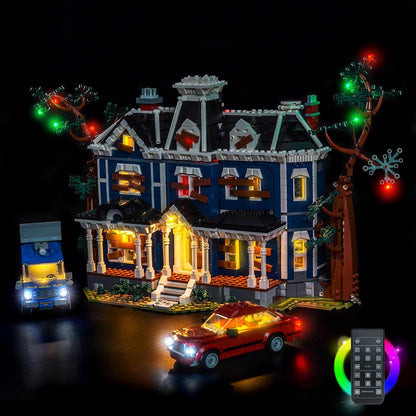 Haunted Victorian house brick model lit with eerie LED lights in a dark room