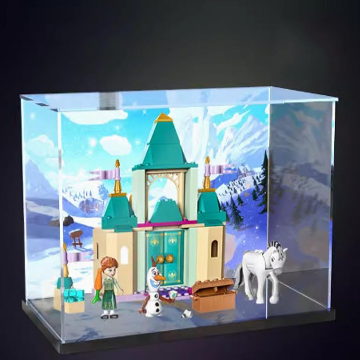 Clear acrylic display case with printed backdrop around a small castle model