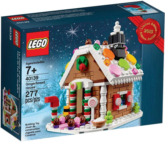 Built mini gingerbread house brick model with white icing roof and candy details