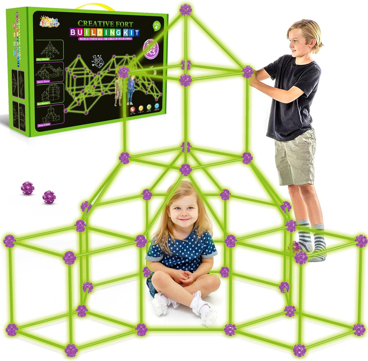 Child-sized fort made of rods and connector balls glowing green in a dark room – view 9