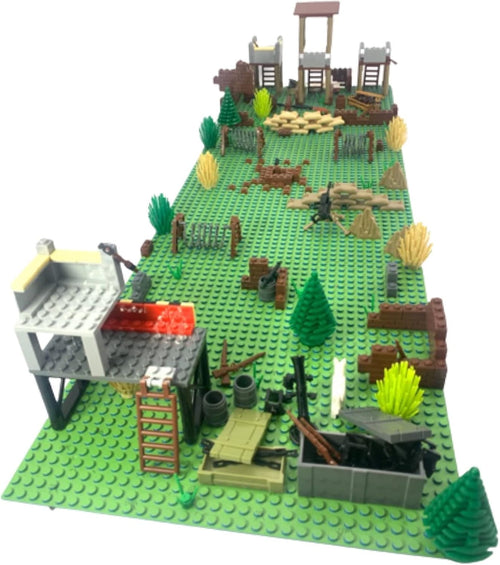 Brick military battlefield scene with small buildings, weapons and barbed wire