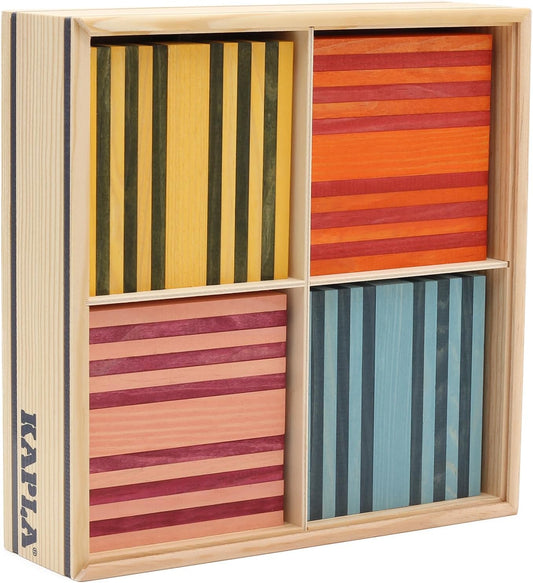 Colorful wooden building planks in eight colors stacked into a tower beside a wooden case
