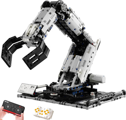Brick-built robotic arm with gripper next to a remote controller
