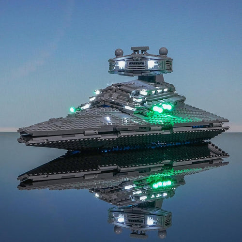 Large wedge-shaped gray brick warship glowing with blue LED engine lights