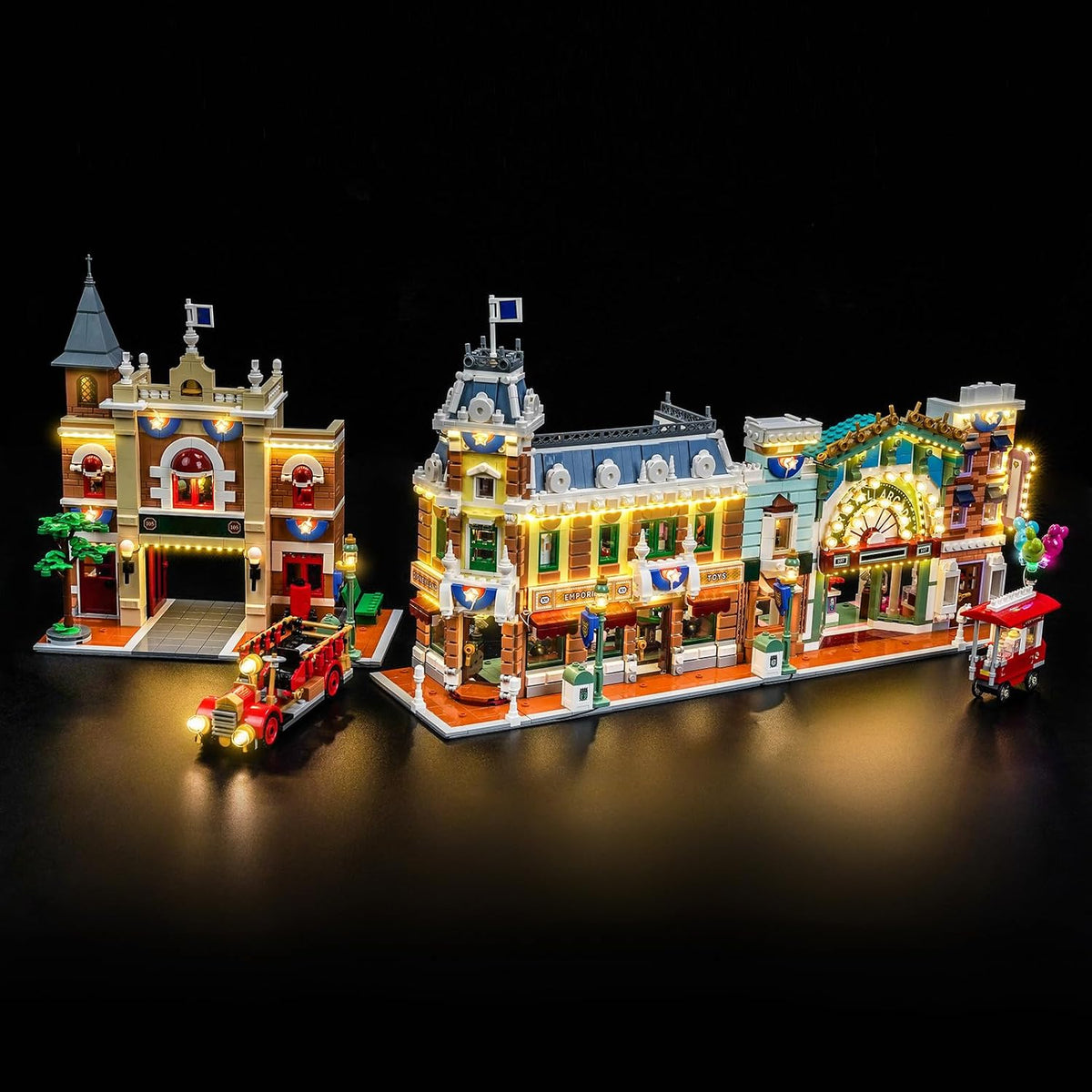 Lit brick-built theme park main street with glowing shopfronts and lamps – view 2