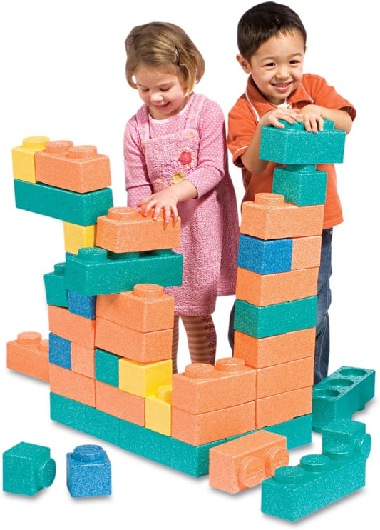 Extra large colorful foam building blocks stacked into a wall