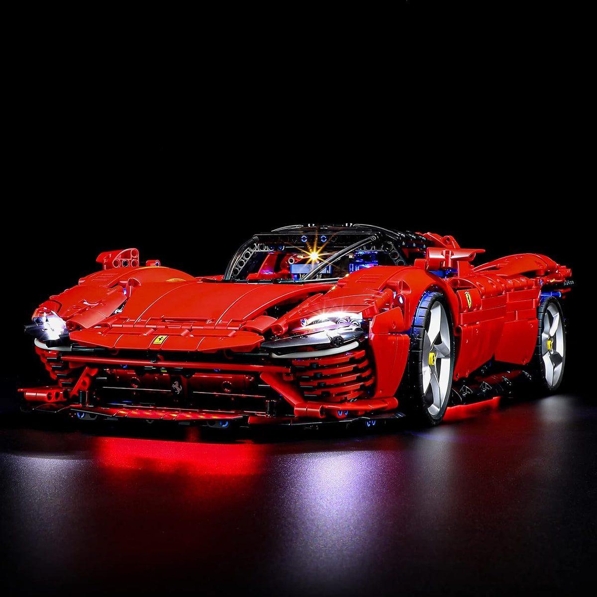 Red Italian supercar brick model with glowing LED headlights and taillights