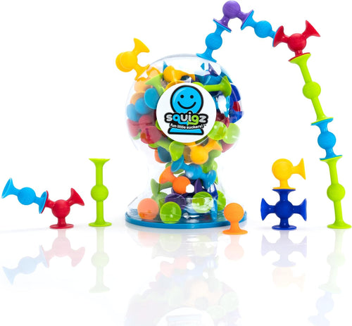Colorful suction cup building pieces stuck together on a bathroom tile wall