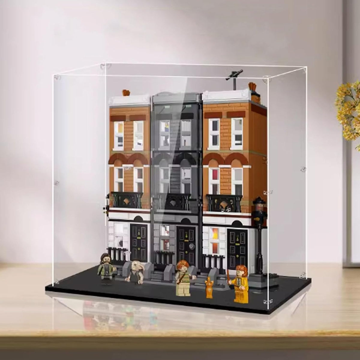 Tall clear acrylic display box around a multi-level plaza brick model