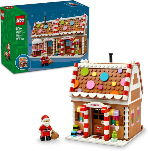 Brick-built Christmas gingerbread house with open interior and Santa figure