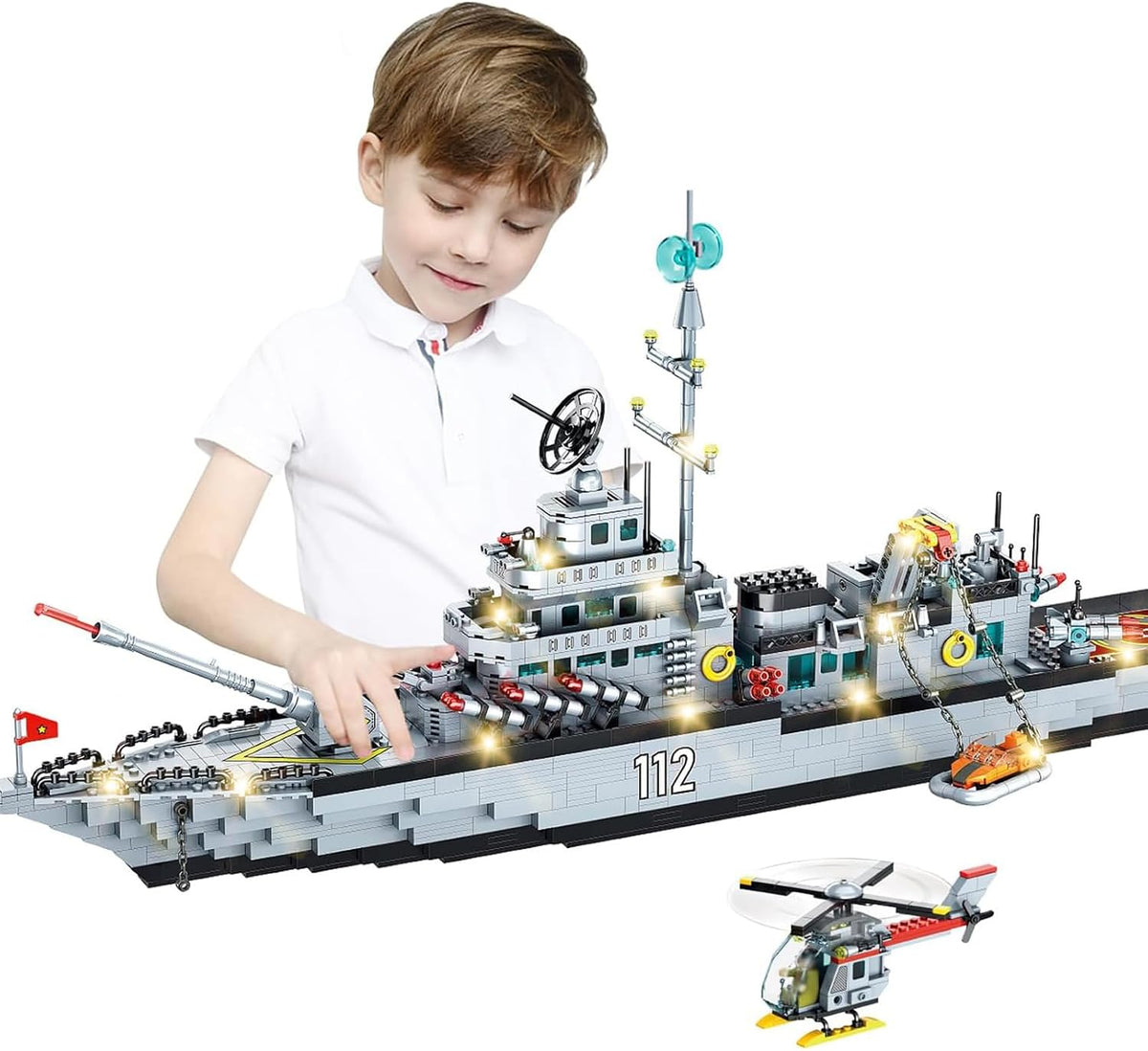 Long brick-built gray WWII navy battleship with gun turrets and helicopter on deck