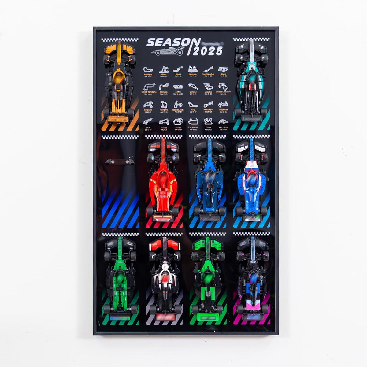 Wall display frame holding several small brick race car models