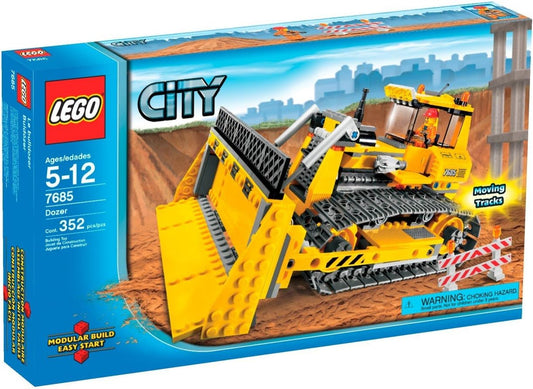 Yellow brick-built tracked bulldozer with raised blade and construction worker figure