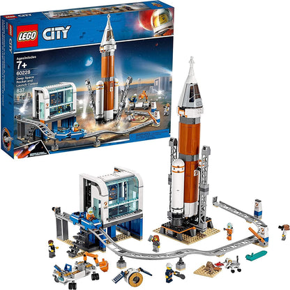 Tall brick rocket in a launch tower beside a control center and monorail – view 2