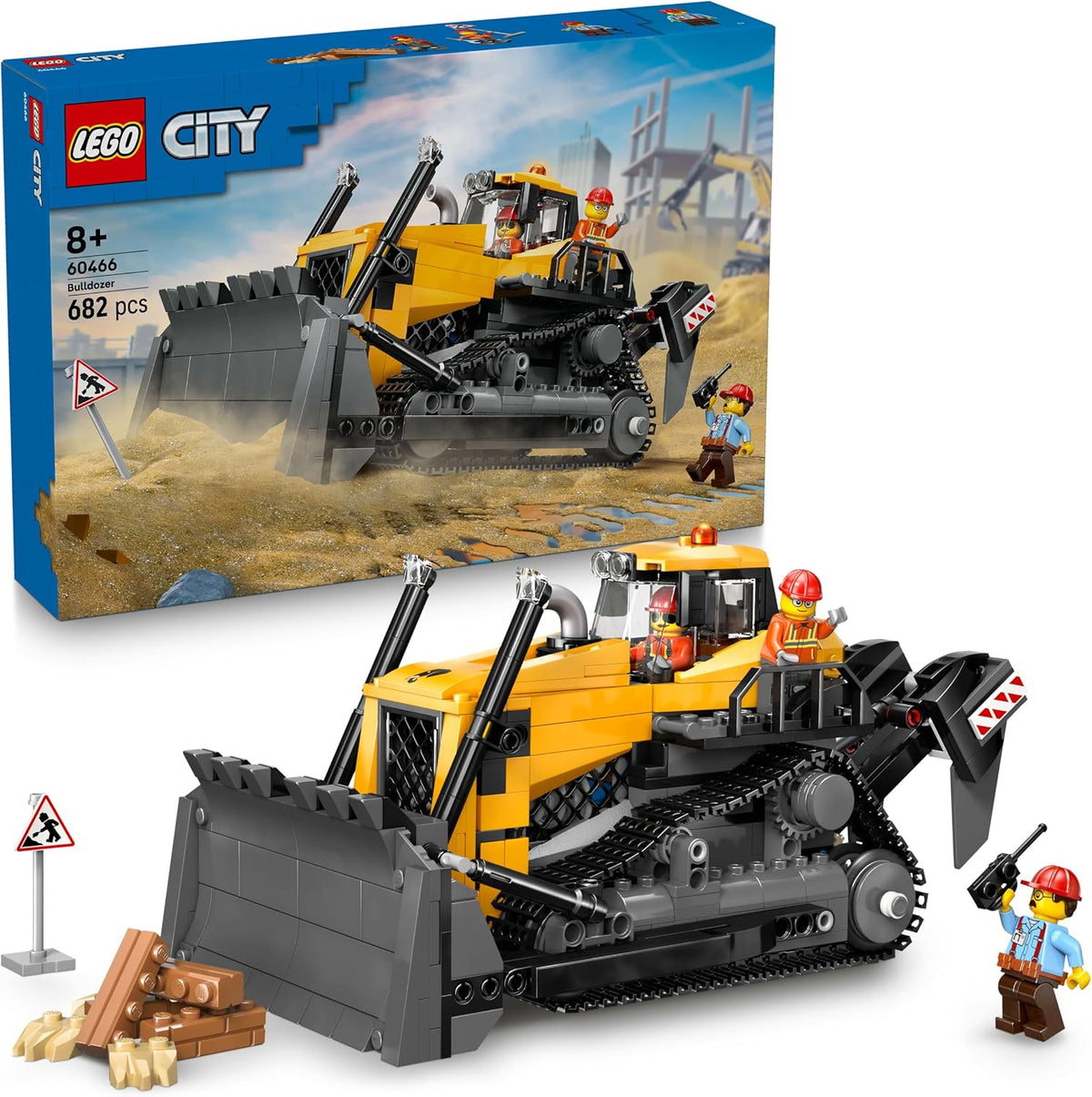 Brick-built yellow bulldozer with raised blade, driver and two workers