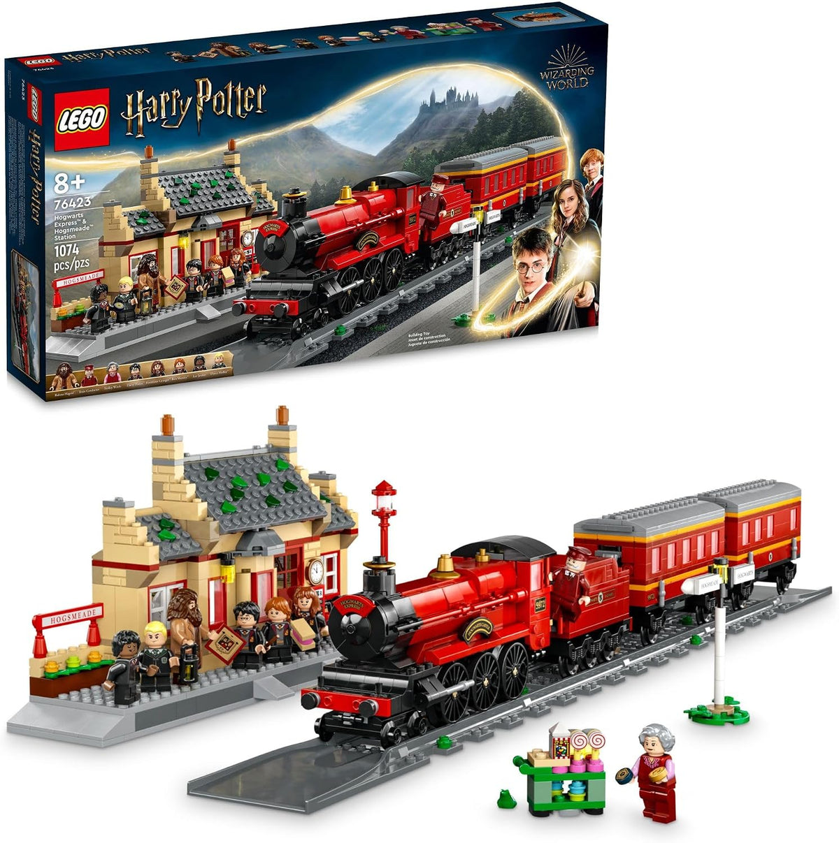 Red brick steam train with carriages at a village station with ticket office