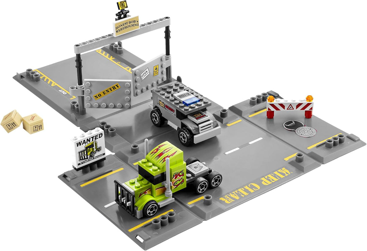 Unfolded case with a road scene, armored security van and green racer truck