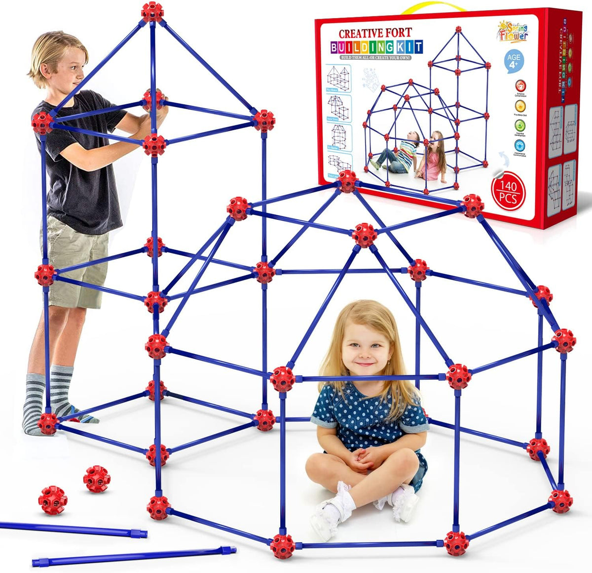 Child-sized fort made of rods and connector balls glowing green in a dark room – view 2