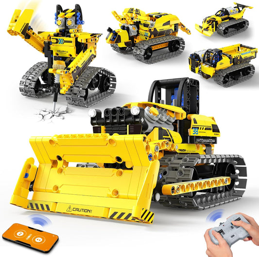 Brick-built bulldozer robot with tracks and front blade beside a remote control