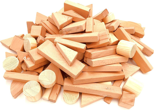 Pile of natural unfinished beech and poplar wooden blocks in assorted shapes