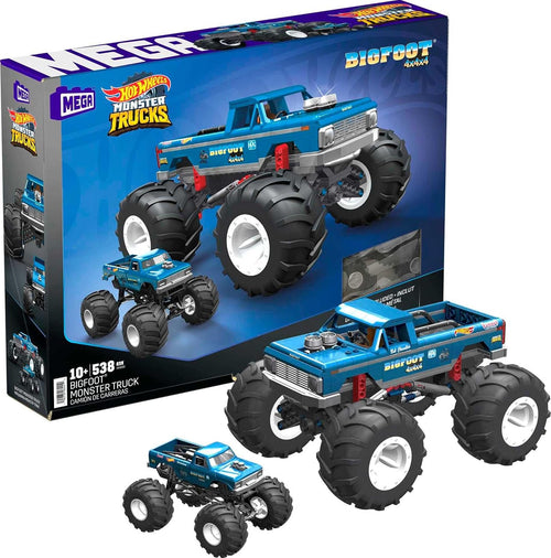 Blue brick monster truck with giant tires beside a small die-cast truck