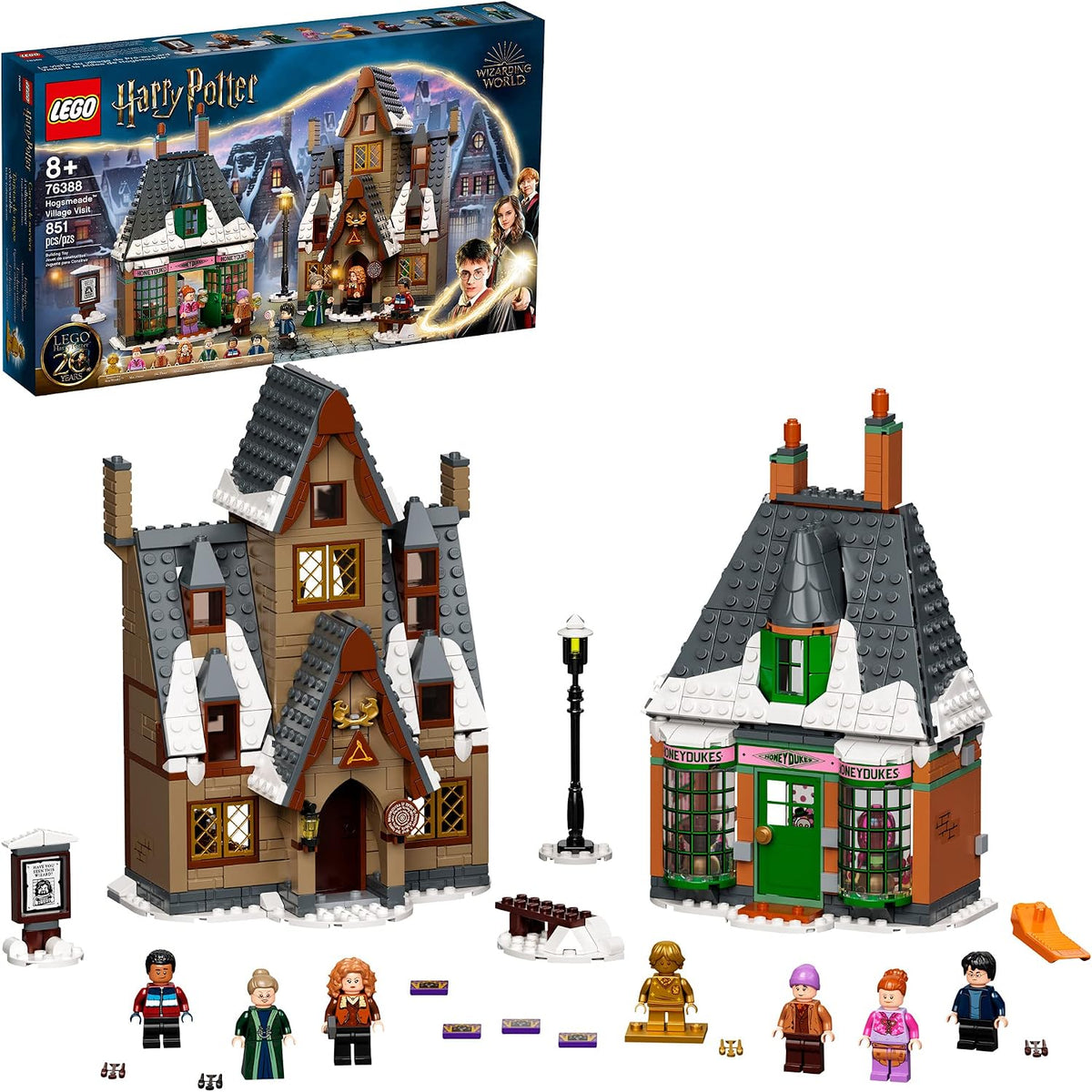 Brick-built wizard village candy store and pub with snowy rooftops and figures