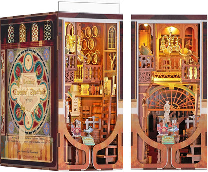 Lit fantasy castle book nook diorama standing between books on a shelf – view 8