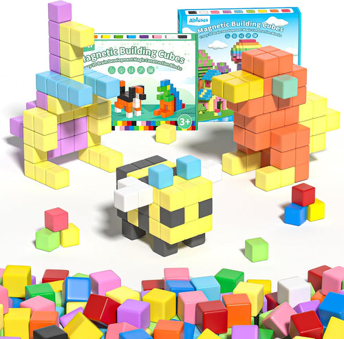 Colorful magnetic building cubes stacked into a small tower and shapes