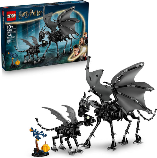 Black brick-built skeletal winged horse with spread fabric wings beside a foal and tree