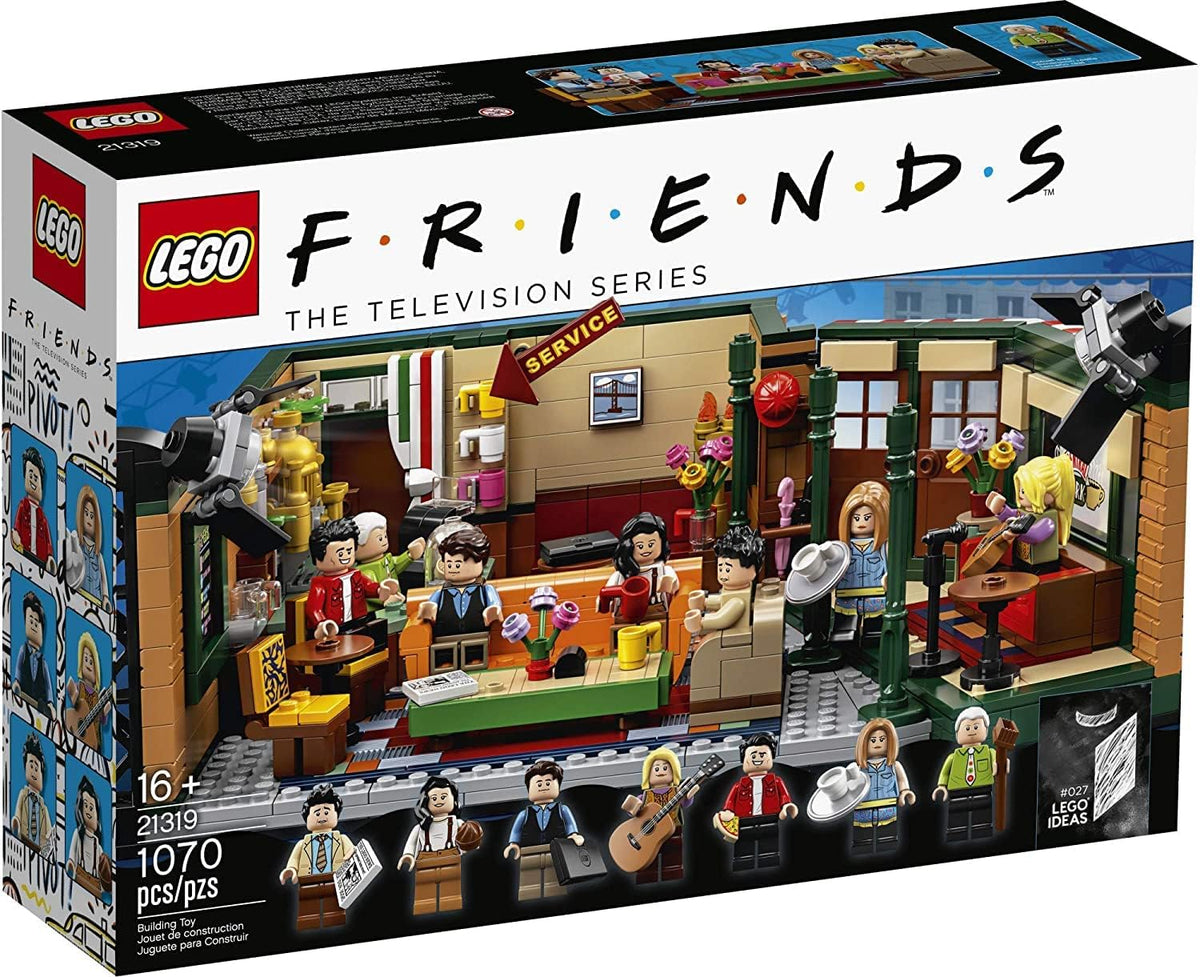 Brick coffee house TV set with orange couch, counter and studio light rigs