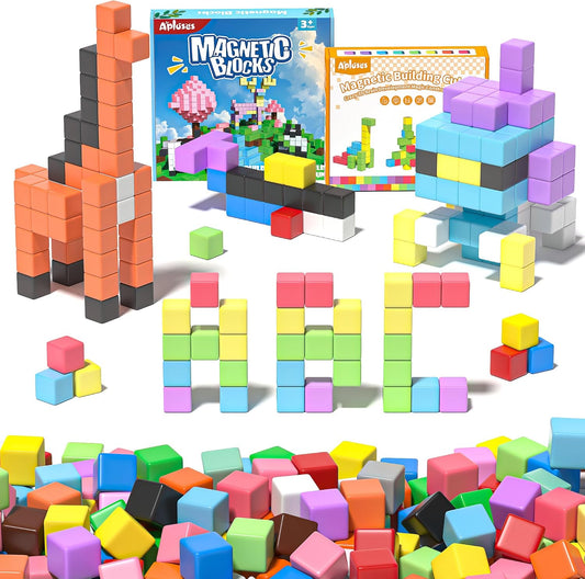 Colorful magnetic cubes stacked into a small tower and rainbow pattern on a play table