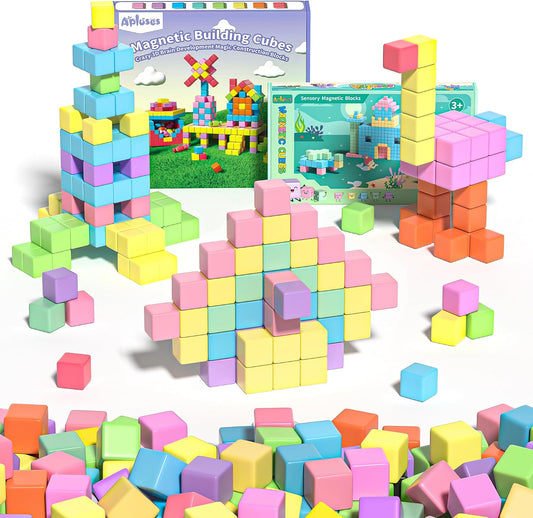 Pile of magnetic cubes in 13 colors next to a storage bag and idea booklet