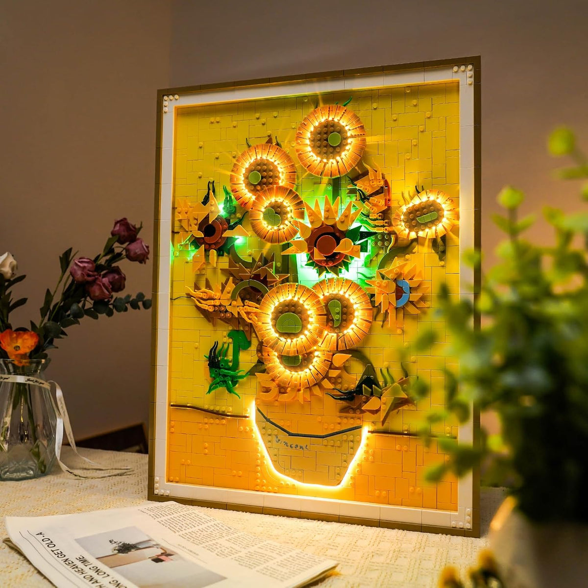 Brick-built sunflowers in a vase painting lit by small LED lights