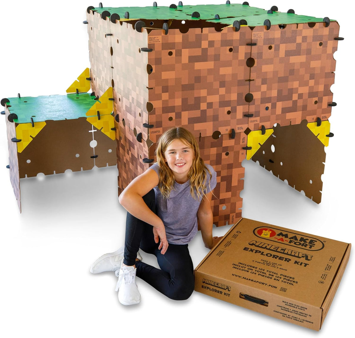 Kids inside a life-size cardboard fort built from pixel-style panels