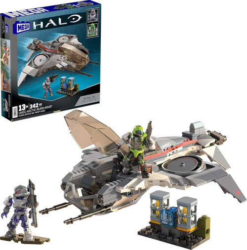 Arctic-camouflage sci-fi gunship brick model beside a charging station and two armored poseable figures
