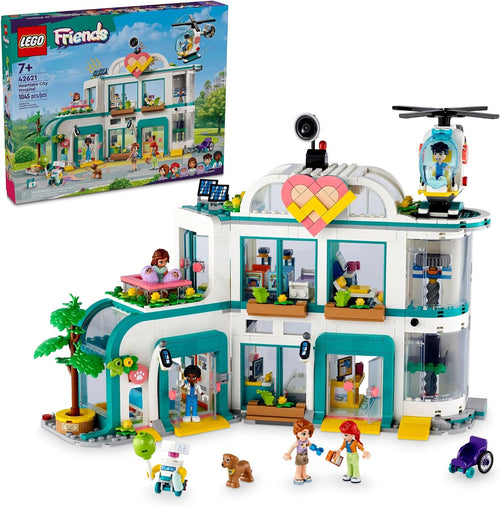 Brick-built hospital playset with open wards, X-ray room and a rescue helicopter beside mini-doll figures