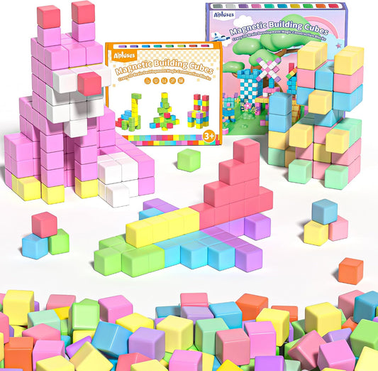 Colorful magnetic building cubes assembled into a house and tower shapes