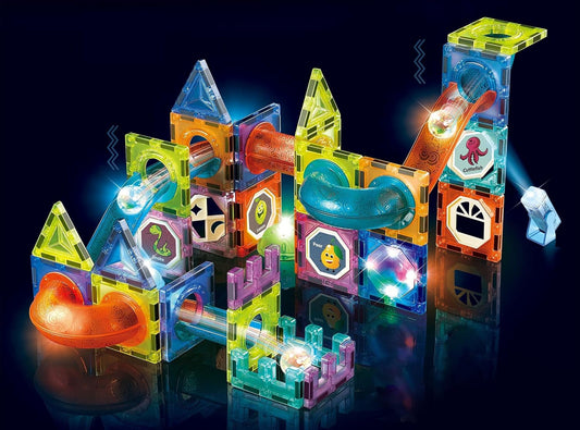 Magnetic tile tower with marble run tracks lit by a colored spotlight
