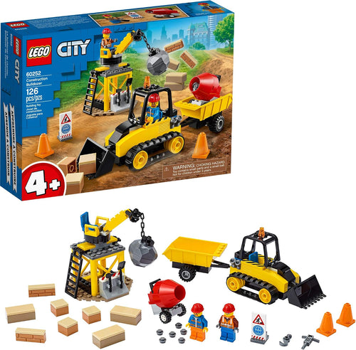 Brick-built yellow bulldozer, wrecking ball and cement mixer at a construction site