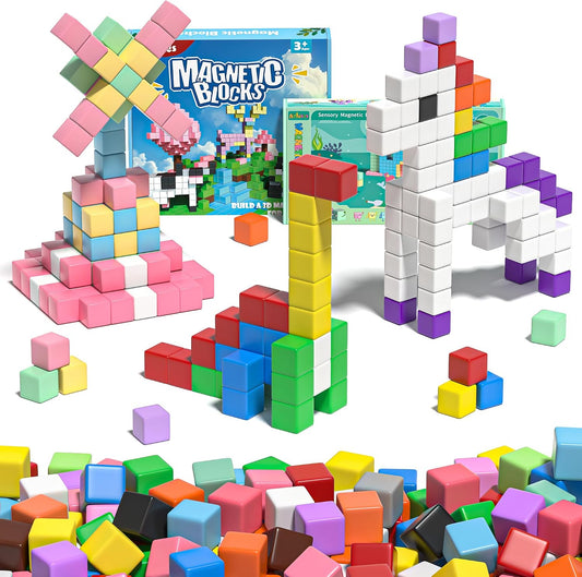 Colorful magnetic building cubes stacked into towers and small scenes