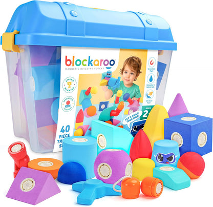 Soft colorful magnetic foam blocks connected into a small tower beside a storage chest – view 3