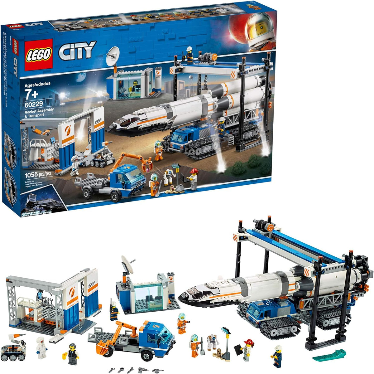 White brick-built rocket on a large crawler beside a control room and space rover