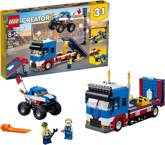 Brick-built monster truck on a transporter with stunt ramps and two figures